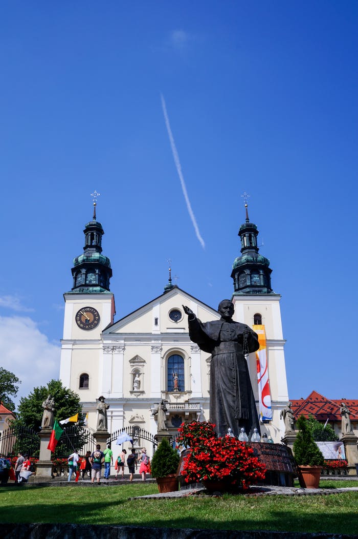 about-01 View of St. Mary's Basilica with Pope John Paul II statue in Wadowice, Poland.
