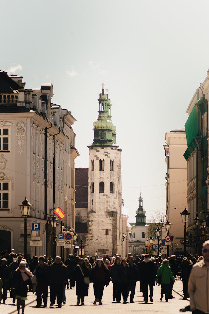 gallery-1 A bustling crowd in Kraków's historic center with St. Andrew's Church as the focal point.