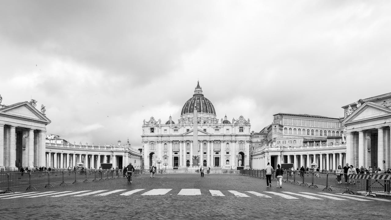 why-choose-us Black and white view of St. Peter's Basilica in Vatican City, showcasing its iconic architecture.